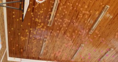 Okulun spor salonunda konfetiye bakan üç kız oğlan basketbolu potadan salya akıtarak atmadan önce. Spor, takım çalışması, kutlama, gençlik, hareket, aktivite, canlı