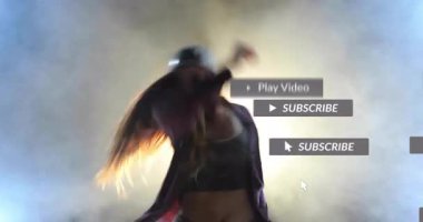 Stüdyoya giren kadın dansçı, abonelik düğmelerine tıklayarak animasyon pazarlama rozetleri üretiyor. Performans, koreografi, hareket, dijital arayüz, görsel efektler, çağdaş yaşam tarzı