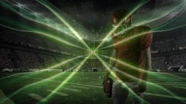 Sahada topu tutan futbolcu güç için etrafında dönen yeşil enerji akımlarını ateşliyor. Sporcu, stadyum, enerji, dijital, turnuva, dinamik, spor