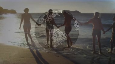 Beş kadın ağırlık değiştiriyor, teknoloji kavramını gösteren dönen dişli küreyle sörf yapıyor. İşbirliği, dostluk, takım çalışması, yenilik, ilerleme, ilham, macera