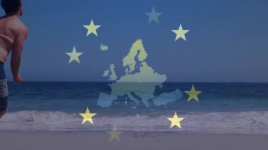 Harita gökyüzünde beliriyor, adam kıyıda koşuyor ve plaj eğlencesi için sarı disk atıyor. Açık hava, etkinlik, spor, egzersiz, eğlence, canlı, enerjik