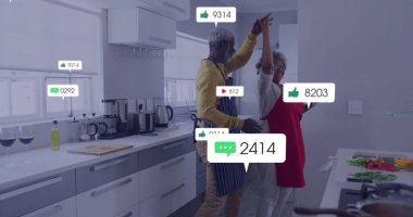 Modern mutfakta dans eden çift, yüzen sosyal ikonlar ve aletlerle yemek hazırlıyor. Aşçılık, mutfak, ev, aşçılık, modern yaşam tarzı, kutlama