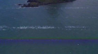 İnsansız hava aracı kamerası okyanus üzerinde yukarı doğru hareket ediyor ve volkanik zirveyi ortaya çıkarıyor. Hava, manzara, tropikal, panoramik, manzara, keşif, macera