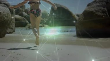 Kumlu sahile ayak basan bir kız körfeze doğru koşuyor. Kıyı, macera, keşif, açık hava, canlı, enerjik, oyuncu