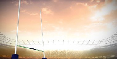 Rugby kaleleri düz dizayn stadyumunda, projektörleri ve tribünleri olan çim sahasında gösteriliyor. Spor, arena, mimari, açık hava, rekabet, kutlama, enerjik