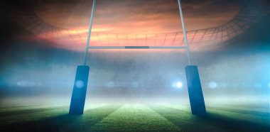 Düz dizayn ragbi stadyumu sisli alacakaranlık gökyüzünün altında parlıyor. Işıklar, kale direkleri, fotokopi alanı. Atletik, görkemli, enerjik, rekabetçi, modern, açık hava, dinamik