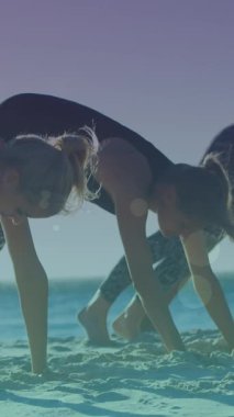 Deniz kenarında egzersiz yapan bir grup bayan arkadaşın üzerinde parlayan ışıkların canlandırması. Arkadaşlık, yaz ve tatil konsepti dijital olarak oluşturulmuş video.