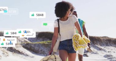 Kumulda yürüyen bir çift plaj ekipmanı taşıyor ve artan çatışmaları gösteren büyüyen medya simgeleri oluşturuyor. Macera, boş zaman, açık hava, yaşam tarzı, canlı, bağlantı, eğlence