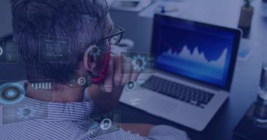 Observing analyst wearing striped shirt analyzing laptop graph with overlays at office, copy space. Technology, data, analytics, innovation, professional, digital, workspace