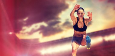 Full length of female athlete jumping against sky during sunset