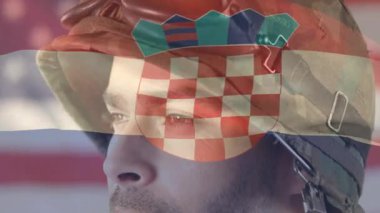 Kasklı asker başını kameraya çeviriyor. Teknolojik demo için işaretli bayrağı gösteriyor. Vatanseverlik, ordu, dayanıklılık, adanmışlık, yiğitlik, kararlılık, güç