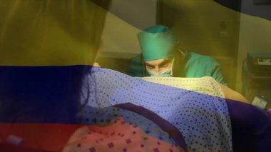 Hamile bir hasta doğum sırasında tırabzana tutunuyor, doktor karnını elle yokluyor ve yol gösteriyor. Annelik, sağlık, klinik, güven, takım çalışması, tanı, sabır