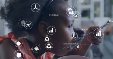 Eating girl analyzing environmental icons at home dining area, with spoon bowl digital overlay. Sustainability, technology, eco-conscious, modern, childhood, innovation, digital