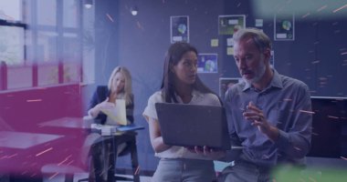 Collaborating professionals in business casual gesturing at laptop in modern office, with charts. Teamwork, communication, strategy, analytics, innovation, productivity, corporate