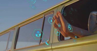 Bare feet resting on yellow van window at roadside, with hex icons, side mirror, copy space. Adventure, freedom, outdoor, travel, relaxation, minimalism, vibrant