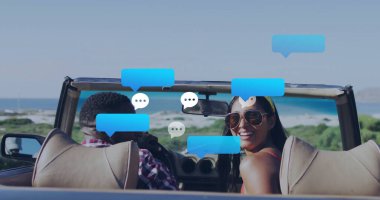 Smiling couple wearing sunglasses chatting in convertible car on coastal road, with chat bubbles. Adventure, leisure, vacation, scenic, travel, outdoor, summer
