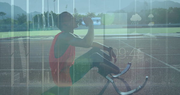 Hydrating teenage male athlete sitting on outdoor track, with prosthetic blades and water bottle. Athlete, sports, performance, outdoor, endurance, training, motivation