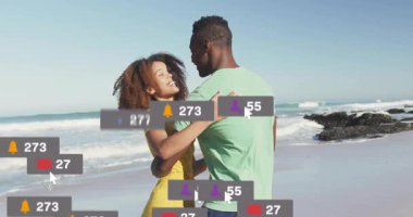 Plajda dans eden çift, sosyal medya bilgilendirme ikonlarının artması ve nişan büyümesini gösteriyor. Romantizm, bağlantı, kutlama, canlılık, zarafet, sahil kenarı, dijital etkileşim