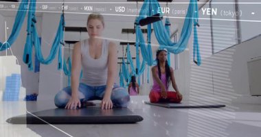 Hamakların altında yoga yapan kadınlar, finans kalbinin derinlere doğru sürüklenmesiyle öne doğru kıvrılıyorlar. Sağlık, esneklik, dinginlik, farkındalık, modern, fitness, rahatlama