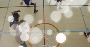 Yukarıdaki kamera kırmızı spor saldırganı, baskette mavi nişancıya pas verirken gösteriyor. Dinamik, takım, rekabet, atletik, hareket, spor, enerji