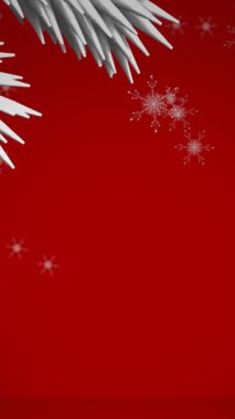 Beyaz Noel ağacı dalları ve kırmızı zemine düşen kar taneleri simgeleri. Noel şenliği ve kutlama konsepti