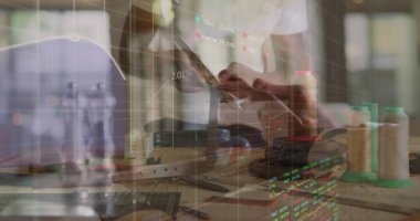 Interacting man in white T-shirt checking fabric with touchscreen in studio, with market overlays. Craftsmanship, innovation, technology, design, analytics, creativity, workspace