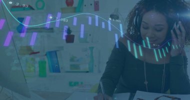 Writing in notebook woman wearing headset analyzing laptop chart overlay in home office, copy space. Productivity, remote work, digital analytics, modern, professional, focused, organized