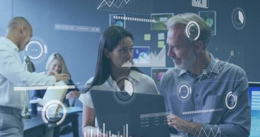 Collaborating senior analyst and project manager reviewing data on laptop in office, with charts. Workplace, collaboration, analytics, technology, modern, communication, business