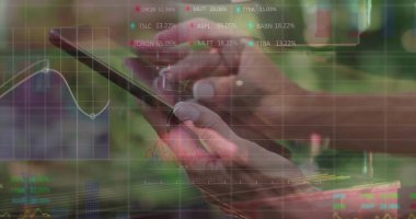 Dijital çalışma alanında akıllı telefonu tutan el ele gösteriliyor, saat, hat çizelgesi ve şebeke örtüleri ile. Teknoloji, finans, analitik, yenilik, veri görselleştirme, dijital, çalışma alanı