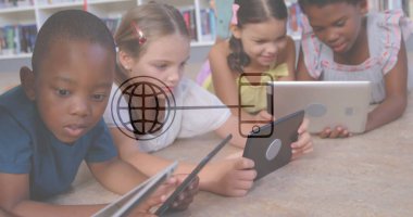 Kitap rafları arkasında, okuma alanında tablet kullanarak renkli kıyafetler giyen dört çocuk yatıyordu. Eğitim, çocukluk, teknoloji, okur yazarlık, öğrenme, çeşitlilik, yenilik