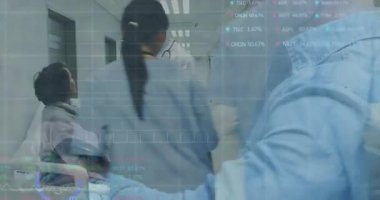 Doktor tıkırtı tableti finans örtüsünü başlatıyor, verileri gözden geçiriyor ve koridorda tekerlekli sandalyeye rehberlik ediyor. Sağlık, profesyonellik, teknoloji, iletişim, hastane, sağlık personeli, hasta bakımı