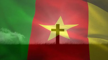Kamerun bayrağı hafif bir esintinin altında dalgalanıyor. Yıldızlar çimenli tümsekte haçın arkasında kayıyor. Vatanseverlik, inanç, maneviyat, açık hava, sembolik, canlı, dinginlik