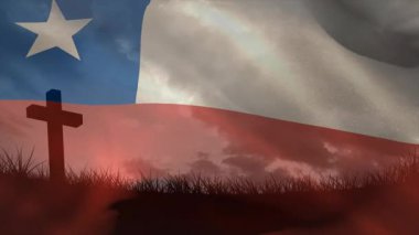 Şili bayrağını açan hafif bir esinti ahşap haç üzerinde dalgalanıyor, bulutların altında çimenler sallanıyor. Vatanseverlik, dinginlik, manzara, açık hava, sembolizm, hareket, sükunet