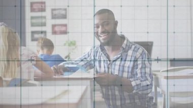 Öğrencilere ders kitaplarında rehberlik eden diz çökmüş öğretmenler eğitim için kameraya gülümseyen sayfalar çevirdiler. Sınıf, akıl hocalığı, gençlik, coşku, bağlılık, öğrenme, etkileşim