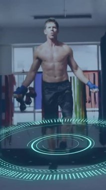 Animation of scope scanning and data processing over caucasian man jumping rope at gym. Global sport and digital interface concept digitally generated video.