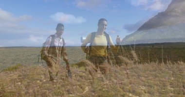 Yürüyen çift yürüyüş kıyafeti giyip çalı çırpı ovalarını yürüyüş direkleri ve sırt çantalarıyla geçiyorlar. Macera, keşif, engebeli, açık hava, doğa, vahşi doğa, dokulu