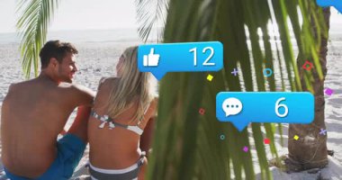 Palmiyelerin altında sahilde oturan ilk çift okyanusa eğilmiş, sosyal simgeler yükseliyor ve düşüyor. Tropikal, boş zaman, dinginlik, romantik, dijital, canlı, yaşam tarzı