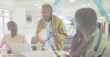 Eğik kreatif direktör elinde renkli çizelgeyi toplantı masasının etrafında dizüstü bilgisayarla tutuyor. Yenilik, işbirliği, takım çalışması, beyin fırtınası, teknoloji, tasarım, profesyonellik