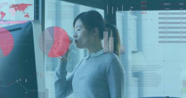 Kurumsal ofis masasında seramik bardak tutan Asyalı analist, veri ekran duvarlı. Profesyonel, işyeri, dijital, analitik, modern, işbirliği, üretkenlik