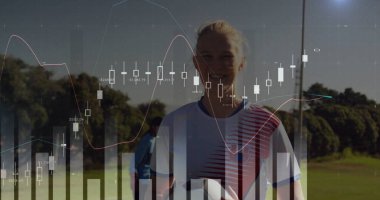 Futbol oyuncusunun spor sahasında top tutarken forma giydiğini ve mali tabloların örtüştüğünü gösteriyor. Atletizm, takım çalışması, açık hava, modern, motivasyon, strateji, canlılık