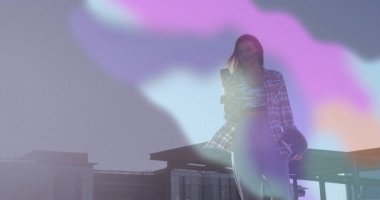 Akıllı telefonu tutmak ve koruyucu kask taşımak, terasta duran kadın, fotokopi alanı. Kentsel, modern, enerjik, serbest, profesyonel, manzaralı, genç