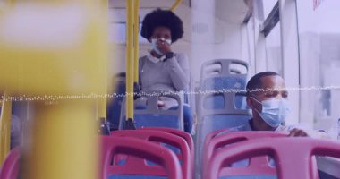 Animation of financial data processing and man and woman in face masks on bus. Covid 19 pandemic, medicine, healthcare, finance, computing and data processing concept digitally generated video.