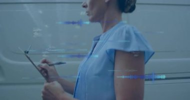 Lojistik koordinatörü minibüsü kontrol ettikten sonra, işçi kutuları tararken operatör kutuyu yüklüyor. Tedarik zinciri, depo, lojistik, envanter, ulaşım, sanayi, dağıtım