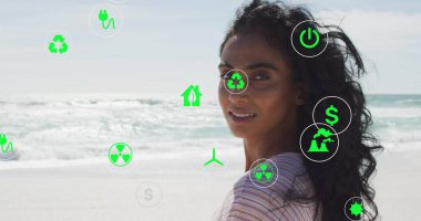 Çizgili bluz giyen bir kadın sahilde geriye bakıyor, yüzen çevresel ikonlar, fotokopi alanı. Sürdürülebilirlik, yenilenebilirlik, çevre dostu, yenilik, iklim, koruma, enerji