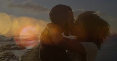 Sahilde deniz ve gökyüzüne karşı öpüşen ve kucaklaşan farklı çiftlerin mercek alevleri. Dijital bileşim, çoklu pozlama, aşk, birliktelik, mutluluk, tatil ve romantizm konsepti.