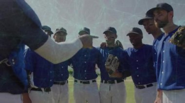 Coach entering huddle and extending arm, motivating baseball team while players focusing. Team, camaraderie, unity, sportsmanship, discipline, outdoor, inspirational