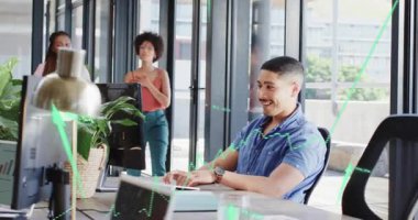 Meslektaşları toplanıp kutlama yaparken, üzerinde yeşil finans şemasını gösteren bir yazı yazan adam. İşbirliği, takım çalışması, yenilik, dijital, profesyonel, çalışma alanı, başarı