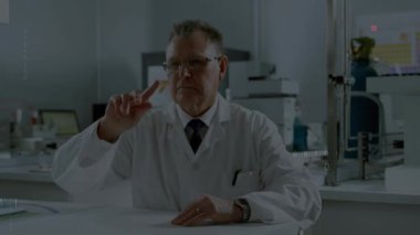 Senior scientist lifting finger on lab bench causing code overlay forming around torso for analysis. Research, innovation, futuristic, technology, data, artificial intelligence, experimentation