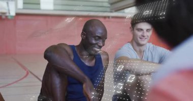 Basketbol sahasına giren koç, takım arkadaşlarının dikkatini çekerek veri örtüsünü analiz etmelerini sağladı. Sporcular, takım çalışması, eğitim, dijital teknoloji, spor analitiği, spor salonu, performans