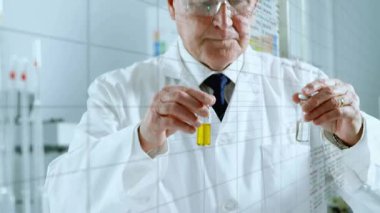 Kıdemli bilim adamı gözlük takıyor ve test tüplerini kimya laboratuvarındaki animasyon çizelgeleriyle karşılaştırıyor. Araştırmacı, deney, veri analizi, yenilik, bilimsel yöntem, laboratuvar ekipmanları, analitik kimya